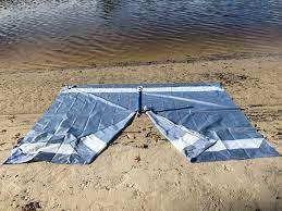 The wildhorn outfitters sand escape beach blanket is reasonably priced, especially considering its large size. Augbrella Beach Mat Beach Blanket With Umbrella Hole Aughog Products Beach Umbrella Sand Anchors Sandbar Anchors And More