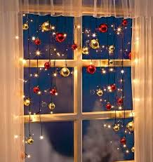 Christmas decoration with lights behind the window. Easy Inexpensive Christmas Window Decoration Ideas For 2020