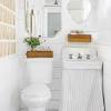 The navy of the tiles is tied in to the color of the walls, and the plant life in the bathroom complements the curtain hanging over the window. 3