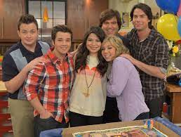 The wooden panel in the background of the photo reads icarly set 1. Icarly Condemns Racism After Hateful Messages To New Star