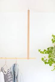 Use a stud finder to locate two ceiling joists in the roof space. Diy Hanging Clothes Rail Burkatron