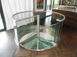 The glass is fixed using stainless steel glass brackets, the landing panels on this staircase were sand blasted. Stainless Steel And Glass Spiral Staircase Foreman Fabricators Inc