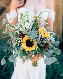 Mix in brown or burgundy sunflowers next to your yellow ones for a fall bouquet. 20 Sunflower Bouquets That Will Brighten Up Your Wedding Day Sunflower Wedding Bouquet Greenery Wedding Bouquet Wedding