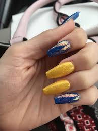 Acrylic nail designs show off your feminine power to the world. Banana Yellow Royal Blue Acrylic Nails Topped With Fairy Dust Blue Acrylic Nails Yellow Nails Design Graduation Nails