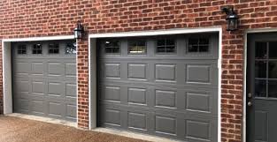 A dark green garage door stands out but isn't distracting. Garage Door Styles And How To Choose The Right One For Your Home Garage Door Styles Garage Door Colors Red Brick House Exterior