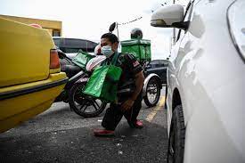 Disabled Delivery Rider On Frontline Of Malaysian Virus War