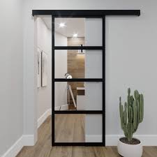 Porte coulissante type atelier avec une partie en verre trempé 5 mm sur le haut et une partie en aluminium composite de 5mm. Porte Coulissante Aluminium Type Atelier Modele Contemporain