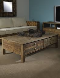 Exquisite color palette in slate gray sofas facing salvaged wood balustrade coffee table, quince green armchairs and accent pillows. Salvaged Wood Coffee Table