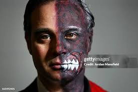 An actor dressed as Two-Face from the film Batman poses for a photo... News  Photo