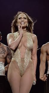Jennifer Lopez is turning heads once again. At 56, the superstar shared a fiery  new video of herself performing her 2001 hit “Play,” dressed in a flame-covered  bra-and-thong set, drop earrings, and