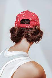 The Baseball Hat Is The Hair Accessory You Ve Been Waiting For Hat Hairstyles Baseball Hat Hairstyles Gym Hairstyles