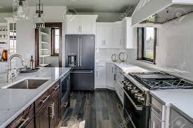 With a clean white finish, this kitchen cabinet adds the space you need without any major construction. Beautiful Kitchen With White Cabinets And Dark Brown Island Stock Photo Picture And Royalty Free Image Image 146682519