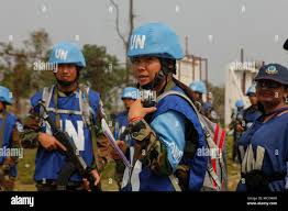 U.N. Peacekeepers from the Royal Cambodian Armed Forces check in with  members of their platoon