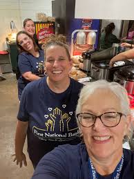 First National Bank staff members (F to B): Jennifer Nichols, Shelly Cook,  Melissa Nickell, and Katie Maples, all lent a hand in the concession stand  during Friday night's game. FNB is always