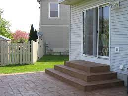 Wooden patio railings provide a decorative element as well as a safety function that describes the paved entertainment area in your backyard. Atlantis Concrete And Construction Llc Decorative Concrete Patio Stairs Patio Steps Stamped Concrete Patio