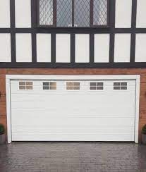 Old garage door openers used something called dip switches. Electric Alutech Sectional Garage Door With 5 Frosted Windows Across The Top Panel M Ribbed Pattern In White Operated By Nrg Black Edition Motor Complete 2x Remote Controls Lt Garage Doors Ltd