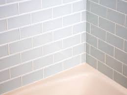 Pry the ceramic tile off its base by inserting the putty knife all the way beneath the tiles until it is deep enough to remove the ceramic tile. How To Install A Shower Tile Wall Hgtv