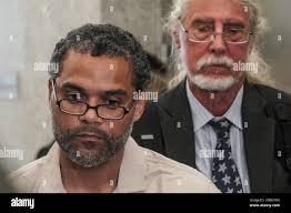 Attorney Ron Kuby, right, listens as his client Thomas Malik talks with  press after his exonerationat Brooklyn Supreme Court, Friday July 15, 2022,  in New York. After decades in prison Malik, Vincent