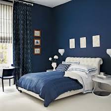Be sure to incorporate some earth tones (e.g., wood furniture pieces) to ground the airy space. Navy Blue Bedroom With Blue Patterned Curtains And White Upholstered Bed Blue Bedroom Walls Blue Master Bedroom Blue Bedroom Decor