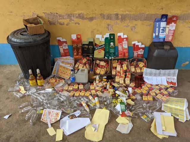 Seized counterfeit alcohol and packaging materials pose severe health risks to unsuspecting consumers., AI generated