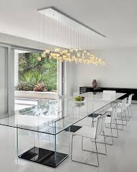 There is no better statement lighting piece than a contemporary chandelier. Dramatic Cascading Chandeliers Unleash Visual Splendor And Pomp Dining Room Contemporary Dining Table Lighting Minimalist Dining Room