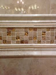 A chair railing is a historic architectural touch. I Love The Gold Trim Tile That Goes From Wall To Wall And Above The Granite Countertop It S Made Up Of A Marble C Pencil Tile Master Bath Remodel Shower Tile