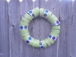 Created This Wreath For My Backyard Fence Used Cat Food Cans With Top Removed And Punched Hole In The Mi Aluminum Can Crafts Tin Can Crafts Green Spray Paint