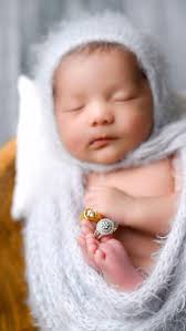 One of my favorite shots to get during newborn sessions is the wedding  rings
