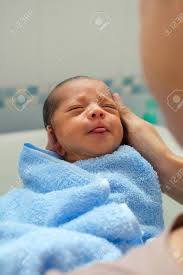 So breakfast trumps morning bath. Asian Father Holding And Bathing Newborn For The First Time Of Life In The Morning Baby Laughing And Feeling Relaxed In The Father S Hand After Taking A Bath Stock Photo Picture And