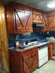 Go ahead and leave a little bit of the grain feel on your collect old wood from sheds and barns and wherever people don't want it and build yourself a set of. Rustic Barn Door Cabinets Bead Board Galvanized Tin Ceiling Lariat Rope Trim Kitchen Cabinet Styles Small Kitchen Decor Kitchen Cabinets