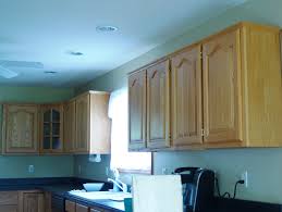 When we finished our kitchen reno last year we decided to forgo any crown molding on the top of our pantry, microwave cabinet, and fridge because we kinda liked the clean, modern look of the square edge (we held some leftover molding up and it didn't look great to us so we crossed that off our list. Diy Kitchen Cabinet Upgrade With Paint And Crown Molding