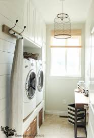 Such a cute and cheap idea!! Love This Farmhouse Style Laundry Room With Raised Washer And Dryer Shiplap Walls And Birdcag Small Laundry Rooms Narrow Laundry Room Laundry Room Inspiration