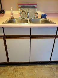 I think you can get away with keeping your wood cabinets for awhile by doing this and going with new stainless appliances. How Could I Redo My Ugly Laminated Kitchen Cabinets Hometalk