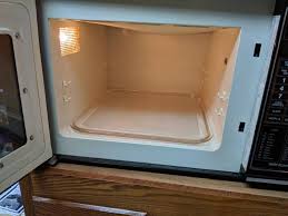It is white in the center, and metal on both ends. Kenmore Solid State Microwave Chaska Moving Auction K Bid