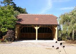 The part of the roof that meets at the peak is a shallower pitch, and the lower section is a much steeper pitch. 2 Bay Garage Catslide Barn Hip Roof Oak Designs