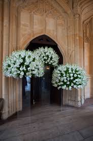Flower Arrangements On Clear Stands Make Them Appear To Be Floating Love Niemierko Weddings Large Flower Arrangements Church Flowers Wedding Entrance Decor