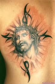 Huge cross on a man's side abs. Black Tribal And Jesus Head Tattoo