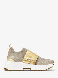 Crafted from a soft knit fabric with a sleek leather strap, our cosmo trainers lend a fashion sensibility to a sporty shape. Michael Kors Cosmo Metallic Knit Slip On Trainer 11 Metallic Knits Slip On Trainers Slip On