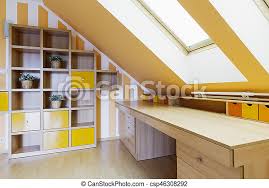 One of our favourite things is create attic office spaces. Yellow Office Room In An Attic With A Set Of Shelves And A Long Wooden Desk Canstock