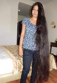 Young, brown haired woman is touching softly owne hair. Long Hair Model Athenea Home Facebook