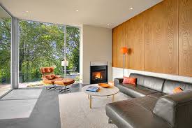 .the modern backyard house is an entire home in itself with the delightful use of square wooden tiles, and mixture of brown and orange colors along with a simple merger of modern neutral shades. Modern House With Fancy Backyard By Shed Architects