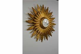 Black metal spires are interspersed with chrome colored spikes with balls at the end. Large Giltwood Sunburst Clock Mid 20th Century Retro Station