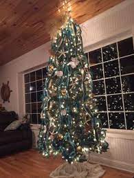 Keep garland in water bottles. 690 Holiday Christmas Coastal Ideas In 2021 Coastal Christmas Beachy Christmas Beach Christmas