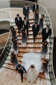 The Wedding Entourage Of Bridesmaids In Ombre Dresses And Groomsmen In Classic Suits Helmed Wedding Entourage Wedding Entourage Dress Ombre Bridesmaid Dresses