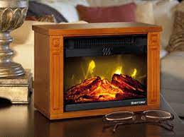 It looks as if real logs are burning. Tiny Amish Fireplace Fireplace Heater Amish Crafts Amish Fireplace