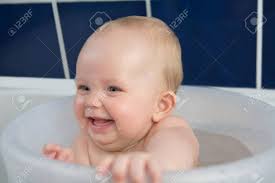It really quietened all three of my children as soon as they went in it as they are up to their neck in warm these look like a large bucket and you simply pop your baby in it in a seated position. Happy Baby Girl Having A Bath In Transparent Bathing Bucket And Smile At Mummy Stock Photo Picture And Royalty Free Image Image 39948566