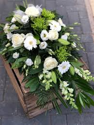 Funeral flowers in cellophane are a flat tied bouquets which are wrapped in cellophane. Modern Tied Sheaf Style Spray Funeral Flowers Vanilla Blue Flowers