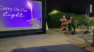 Vicky Lynch & Carlos V. Ramos performing at the 2023 Annual Overdose Vigil  by Candlelight