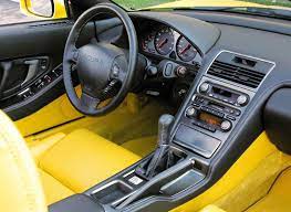 At a glance the honda's interior is all a bit dan dare, an array of digital dials and numerous buttons make it more starship than car. Honda Nsx