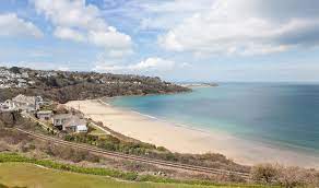 Around a mile long, the golden sand glistens in the bright light of west cornwall. Carbis Bay Beach St Ives Cornwall